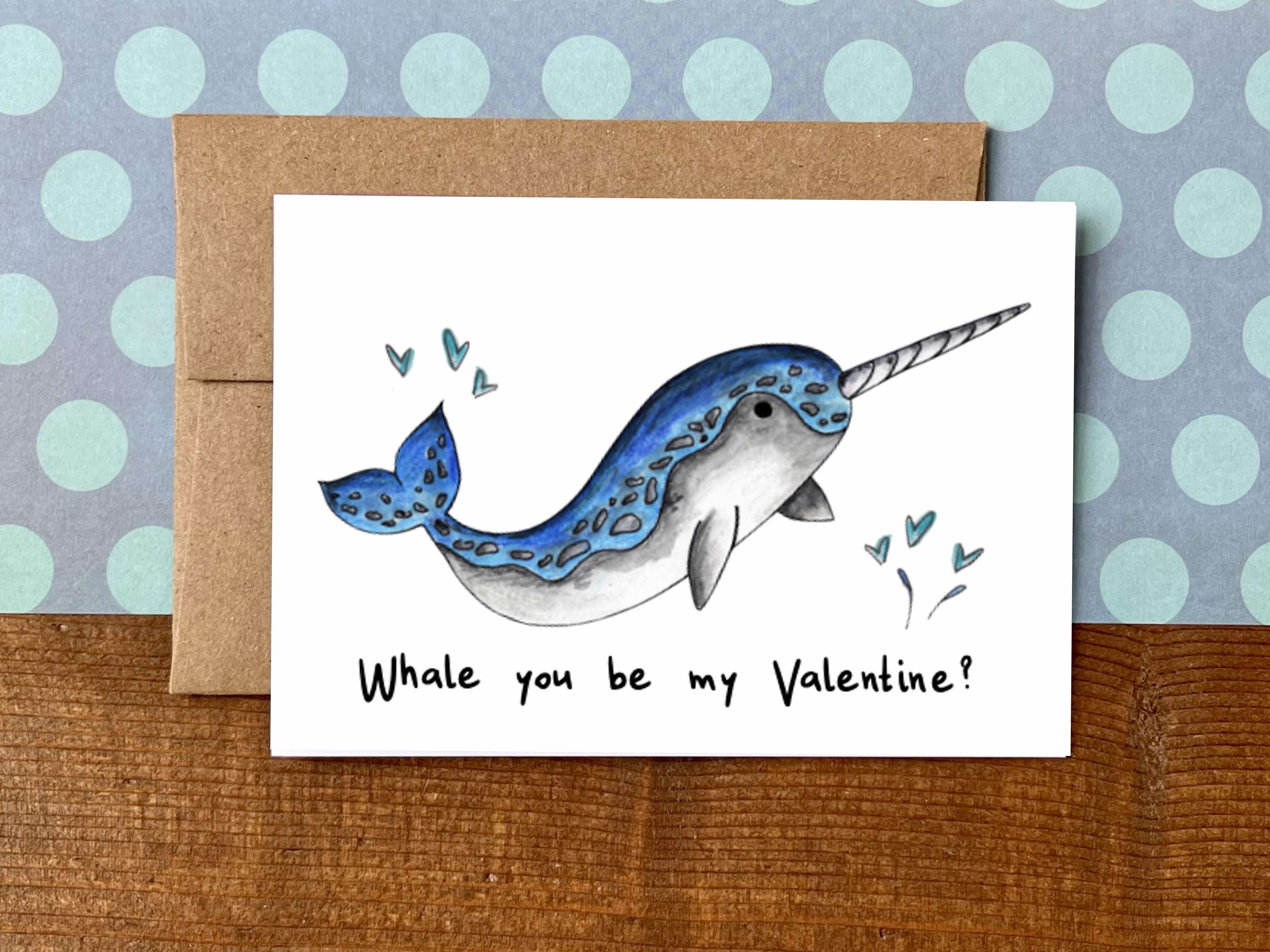 A Valentine's Day note card with an illustration of a narwhal and the message "Whale you be myValentine?"