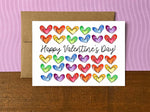 A Valentine's Day note card with rows of rainbow colored hearts and the message "Happy Valentine's Day!"