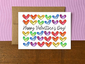 A Valentine's Day note card with rows of rainbow colored hearts and the message "Happy Valentine's Day!"